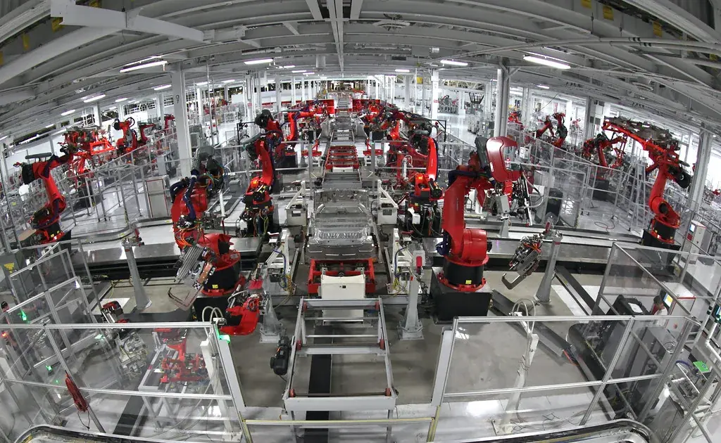 Robots welding car bodies on an automotive assembly line