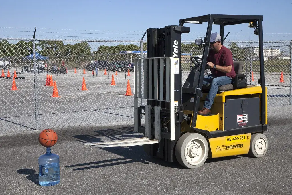Operator seated at the controls of a forklift on a marked course