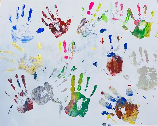 Our Holi handprint board, signed by the team