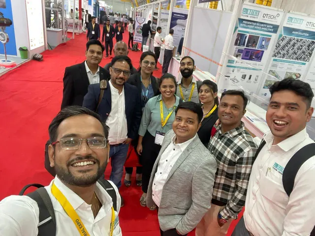 The team at an industrial expo, beside the D-TECH and Matrix stand